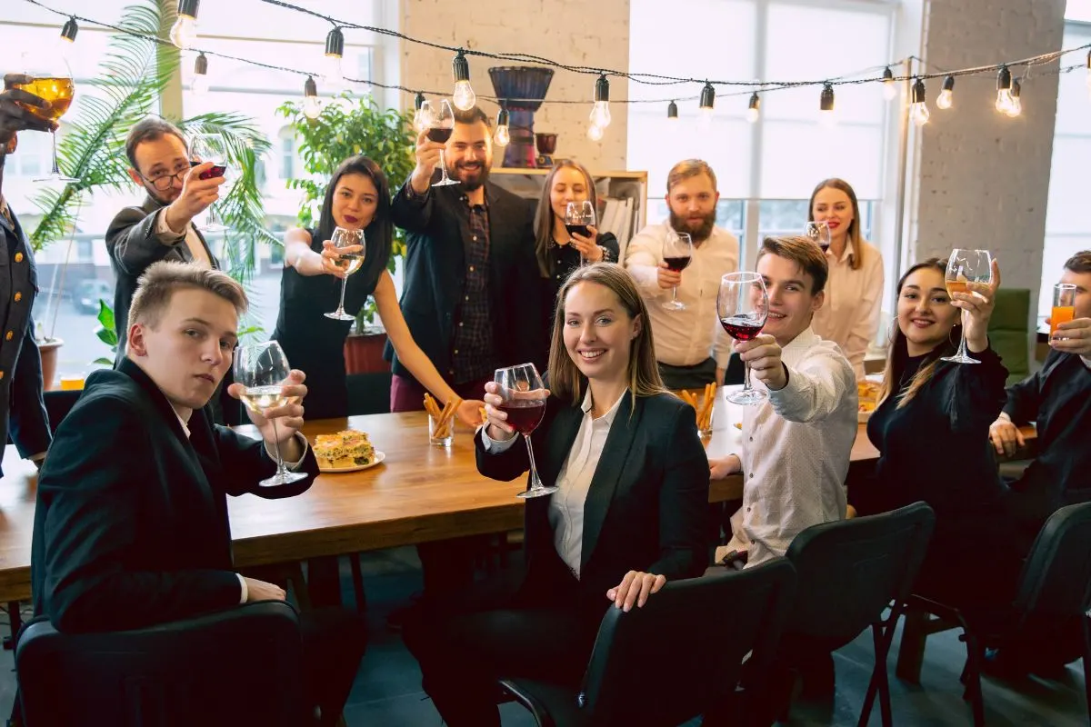 Team members raising glasses and smiling at a corporate event showcasing creative entertainment ideas for corporate events