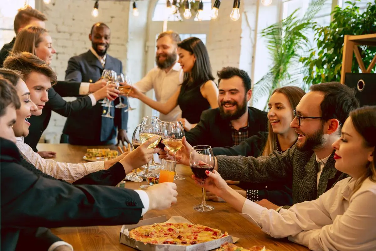 Group of professionals toasting with wine glasses at a corporate event celebrating entertainment ideas for corporate events