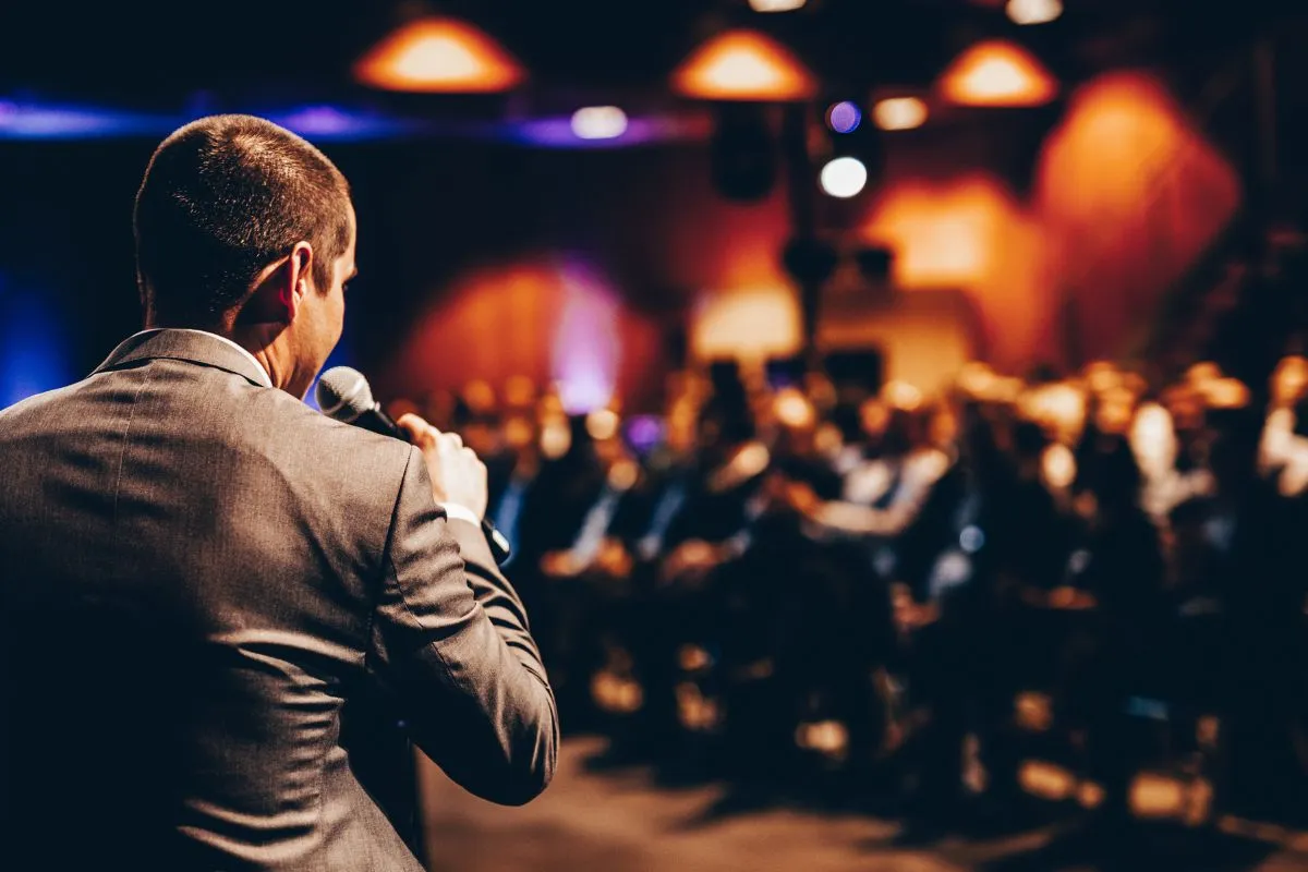 Speaker presenting to an engaged audience at a professional corporate event