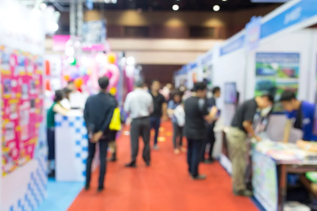 Attendees networking at a busy event exhibition hall – how do you make an event successful with strong engagement