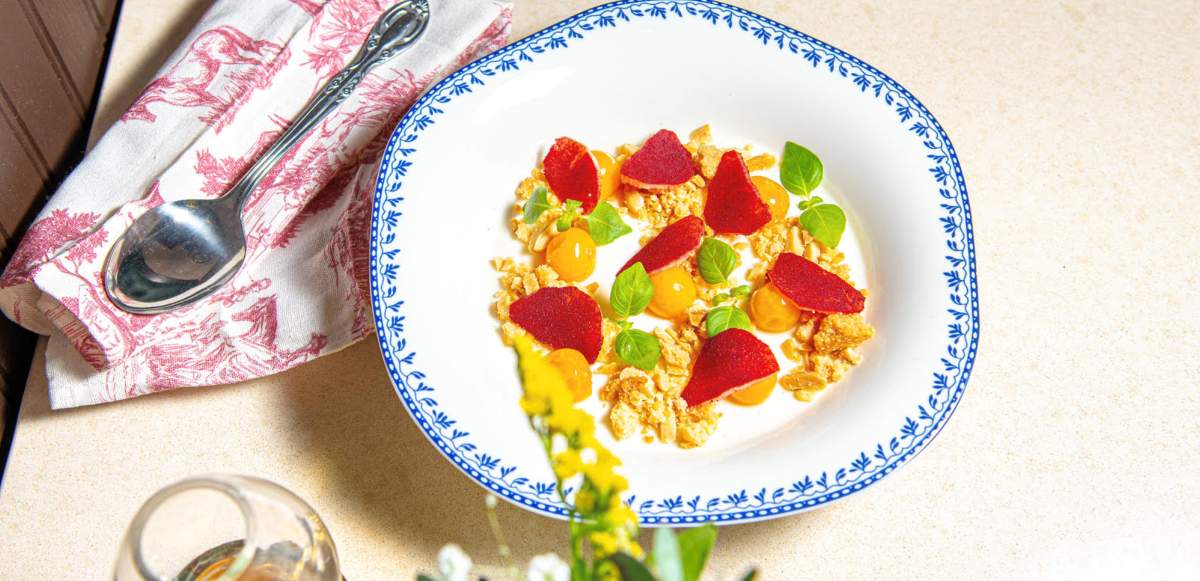 gourmet dish served in a wide-rimmed white bowl with a delicate blue patterned border