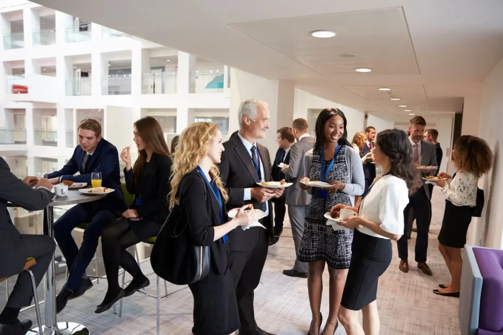 Business professionals mingling and networking during a break at a corporate event organized through strategic event planning for corporate events