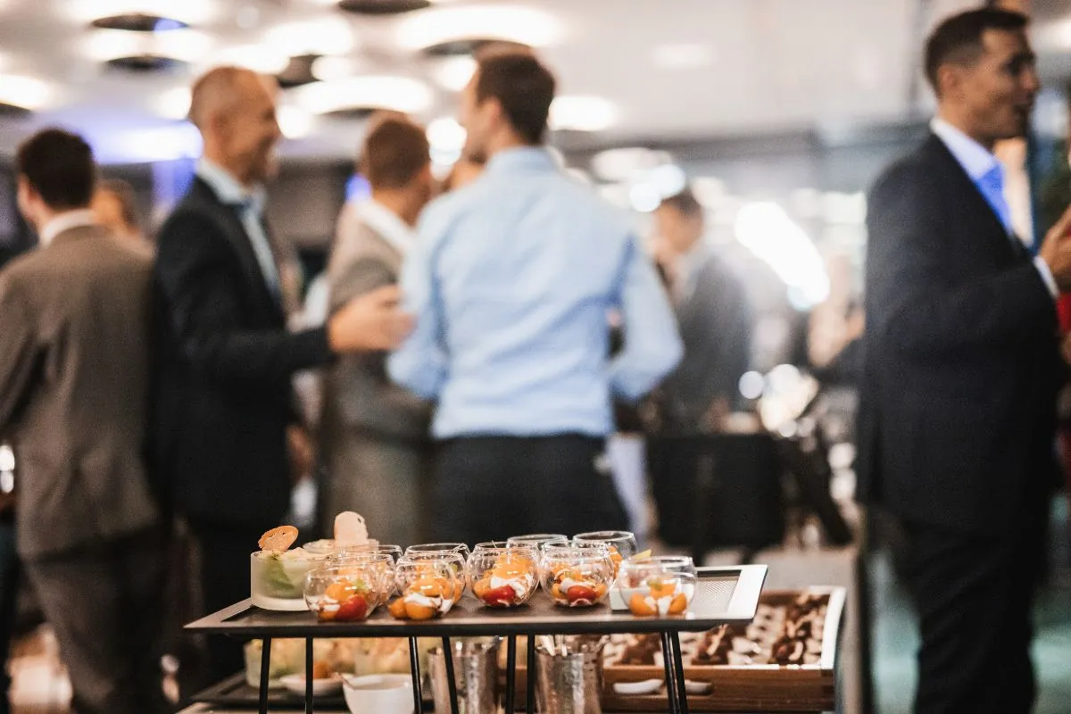 Professionals networking over gourmet appetizers at a corporate event planned with expert event planning for corporate events