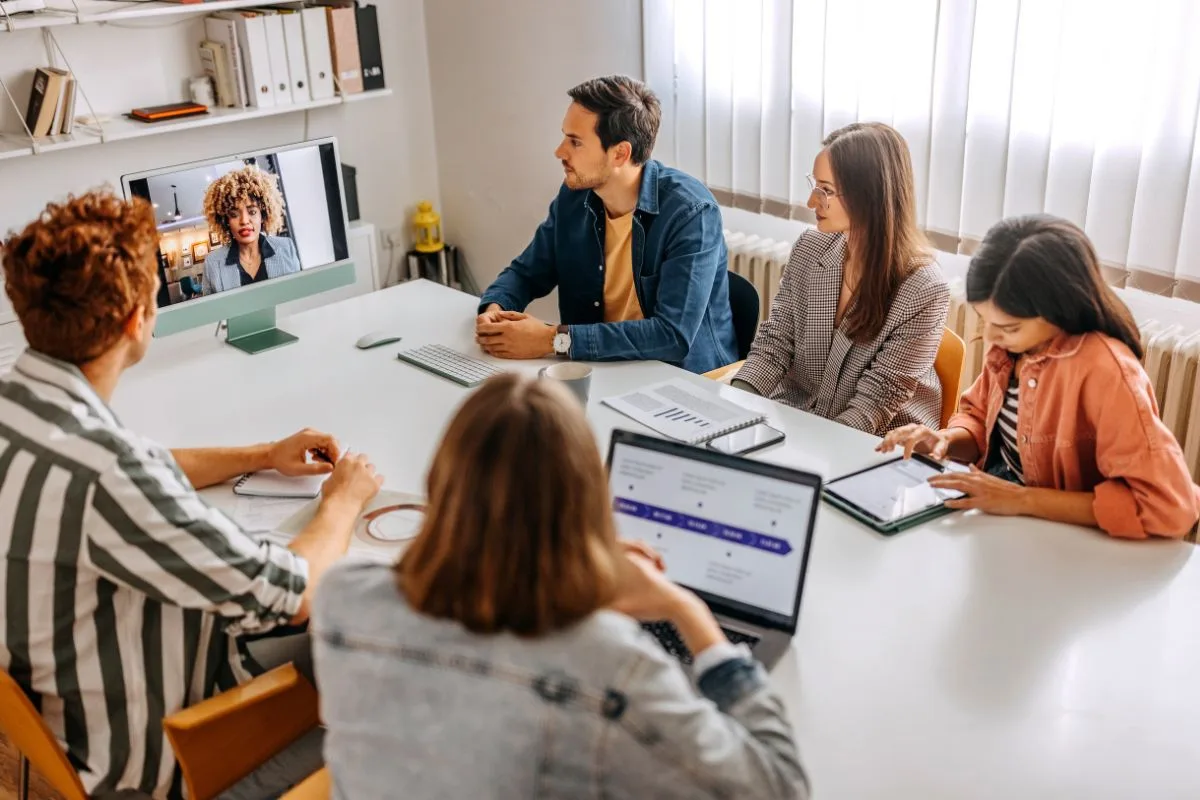 Hybrid event planning: in-person team connecting with virtual attendee