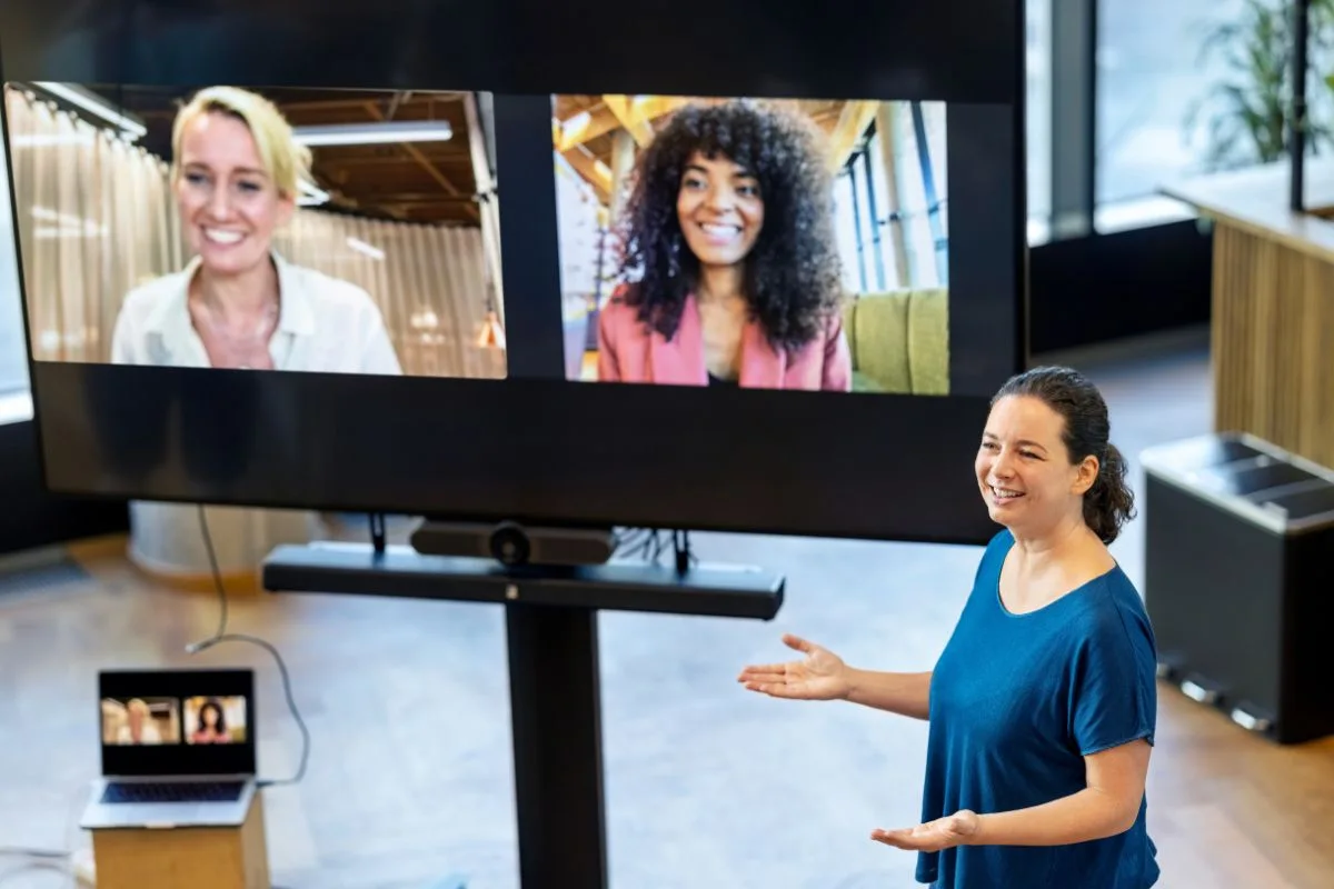 Hybrid event planning: presenter engaging remote participants on large screen