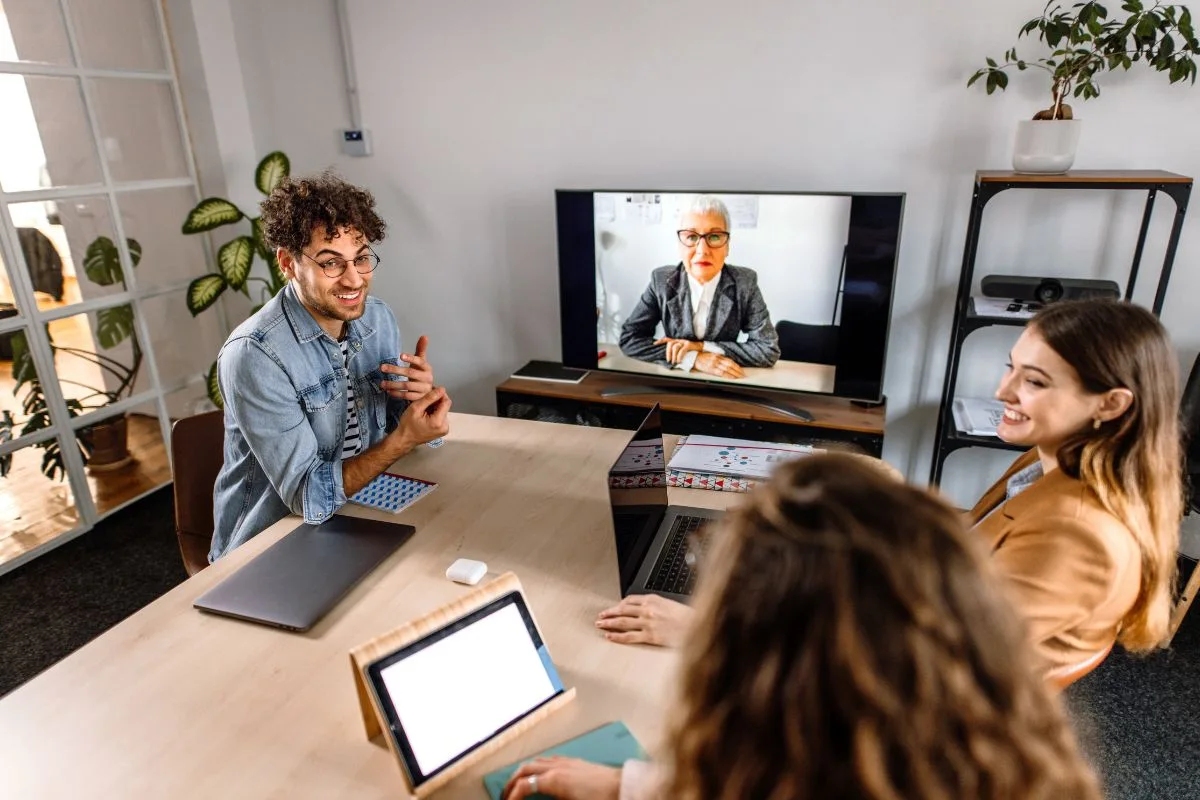 Hybrid event planning: team meeting with remote attendee on screen